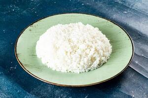 Plain boiled rice in a plate top view on marble background photo