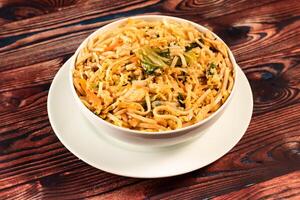 Traditional Spicy chow mein in a bowl isolated on marble background top view of chinese noodles photo