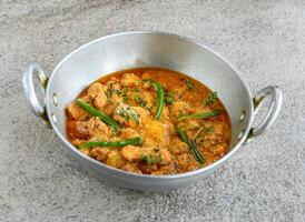 chicken boneless handi korma served in karahi isolated on grey background top view of pakistani and indian spices food photo