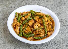 chicken ginger served in plate isolated on grey background top view of pakistani and indian spices food photo