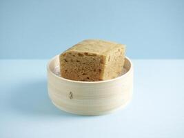 Steamed Black Sugar Sponge Cake with chopsticks served in a dish isolated on mat side view on grey background photo