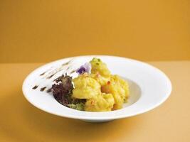 Crispy fried Crystal Prawns tossed with Salted Egg Yolk with chopsticks served in a dish isolated on mat side view on grey background photo