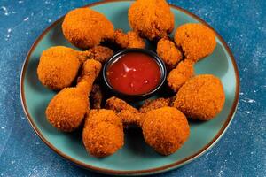 Deep fried Chicken Lolipop or Chicken drumstick with tomato sauce and mayo dip served in a dish isolated on background side view photo