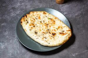 Butter naan or cheesy roti served in dish isolated on grey background top view of indian and bangladesh food photo