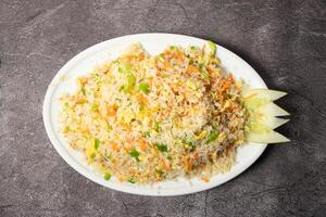 Egg Fried Rice with capsicum and cucumber served in dish isolated on background top view of bangladesh food photo