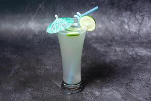 Fresh Lemon Juice with straw served in glass isolated on grey background top view of indian and bangladesh food photo