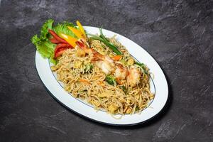 Thai Noodles with shrimp served in dish isolated on grey background top view of indian and bangladesh food photo