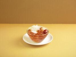 Double-boiled Peach Resin with American Ginseng served in a bowl isolated on mat side view on grey background photo