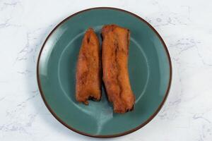 deep fried brinjal pakora or beguni served in a dish isolated on background top view of Indian and bengali food photo