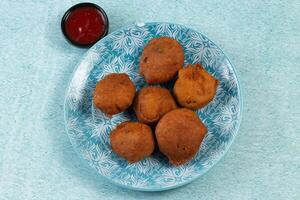 deep fried potato chop served in a dish isolated on table side view photo