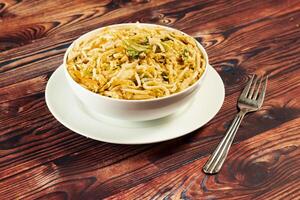 Traditional Spicy chow mein in a bowl isolated on marble background top view of chinese noodles photo