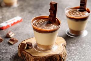 Kinder chocolate cheesecake served in cup isolated on wooden board top view cafe cheese cake food dessert photo