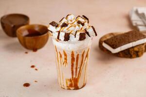 Caramel frappe with Ice Cream sandwich with chocolate served in glass isolated on table top cafe dessert Frappuccino Blended drink photo