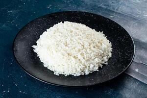 Plain boiled rice in a plate top view on marble background photo