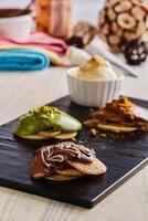 MIni Pancake with strawberry, hot chocolate and caramel served in wooden board isolated on background top view of cafe baked food photo