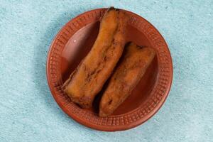 deep fried brinjal pakora or beguni served in a dish isolated on background top view of Indian and bengali food photo