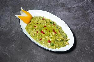 Green chicken Curry served in dish isolated on grey background top view of indian and bangladesh food photo