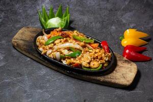 Chicken sizzling served in dish isolated on grey background top view of indian and bangladesh food photo