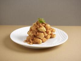 crispy fried eggplant with pork floss served in a dish isolated on background side view photo