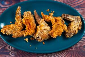 Crispy chicken wings with tomato sauce and mayo dip isolated on cutting board side view of fastfood photo