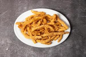 French Fries and potato chips served in dish isolated on background top view of bangladesh food photo