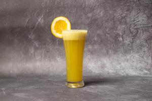 Fresh orange with orange slice served in glass isolated on background top view of bangladesh food photo