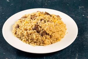 Traditional spicy indian Beef Biryani in a plate on marble background top view of pakistani pulao photo