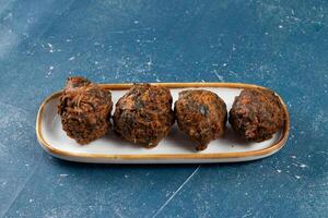 Indian spicy vegetable pakora or pakoda served in dish isolated on table top view photo