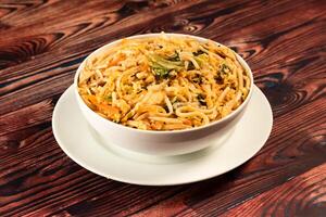 Traditional Spicy chow mein in a bowl isolated on marble background top view of chinese noodles photo