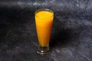 Papaya Juice served in glass isolated on grey background top view of indian and bangladesh food photo