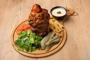 Chicken shawarma with salad, fries and dip served in dish isolated on table top view of arabian food photo