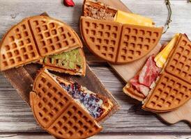 Assorted waffle with Grape Souffle, Pesto Bacon, Red Bean Matcha, tuna cheese, Chocolate Condensed Milk, served on wooden board isolated on table top view of dessert photo