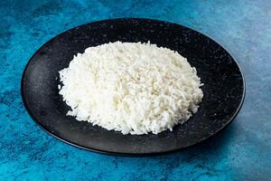 Plain boiled rice in a plate top view on marble background photo