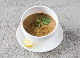 lentil soup with lemon served in bowl isolated on background top view of Arabic fast food photo