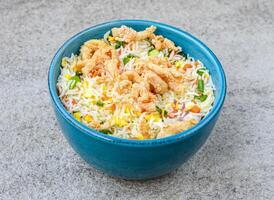 chicken fried rice served in bowl isolated on background top view of asian food photo