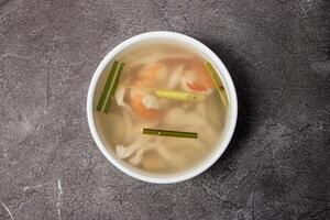 Thai Clear Soup with shrimp and veg served in bowl isolated on background top view of bangladesh food photo