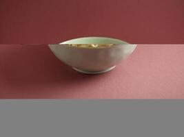 Signature Canton Jumbo Prawn Wanton Noodle with chopsticks served in a bowl isolated on mat side view on grey background photo