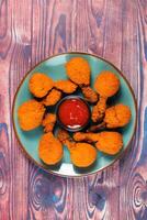 Deep fried Chicken Lolipop or Chicken drumstick with tomato sauce and mayo dip served in a dish isolated on background side view photo