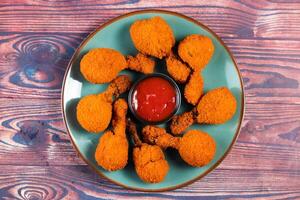 Deep fried Chicken Lolipop or Chicken drumstick with tomato sauce and mayo dip served in a dish isolated on background side view photo