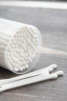 Macro view of white cotton ear cleaning buds arranged in white backgroud nicely in a container photo