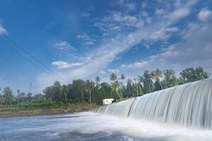 A beautiful view of a waterfall from a check dam In Kerala, India. photo