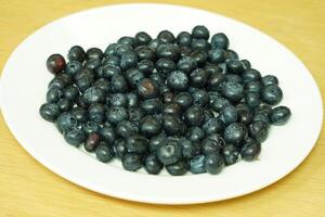 closeup view of Blueberries in a plate on the table photo