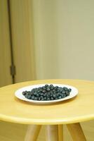 closeup view of Blueberries in a plate on the table photo