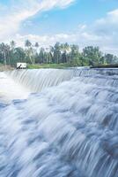 A beautiful view of a waterfall from a check dam In Kerala, India. photo