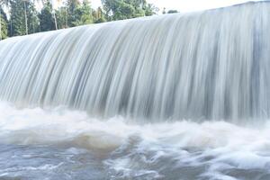 A beautiful view of a waterfall from a check dam In Kerala, India. photo