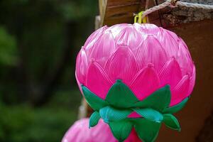 Colourful Korean lanterns arranged in a raw infront of a temple photo