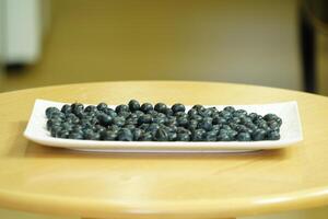 closeup view of Blueberries in a plate on the table photo