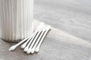 Macro view of white cotton ear cleaning buds arranged in white backgroud nicely in a container photo