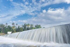 A beautiful view of a waterfall from a check dam In Kerala, India. photo