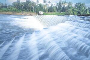 A beautiful view of a waterfall from a check dam In Kerala, India. photo